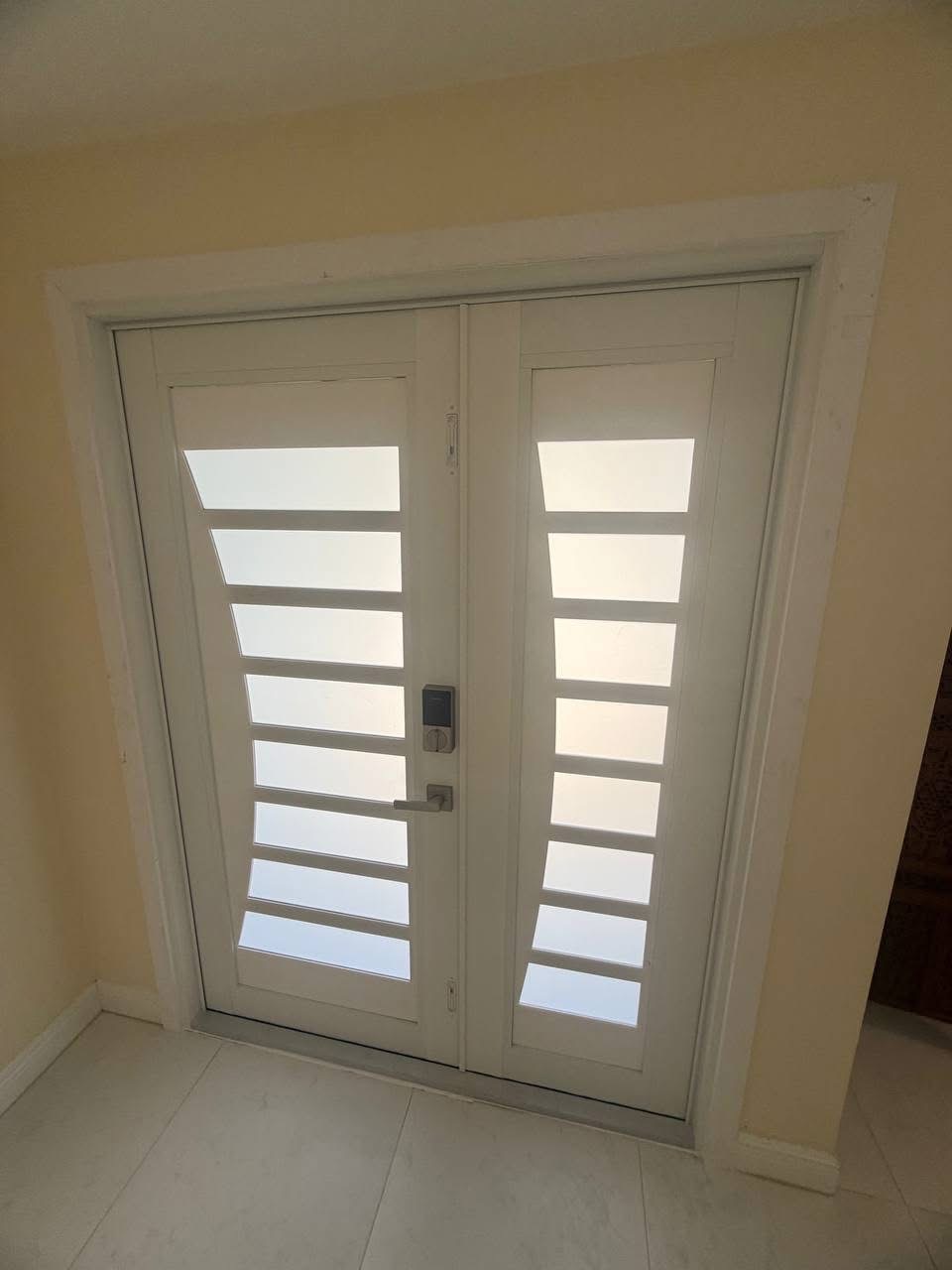 White impact entry door with circular geometric motif