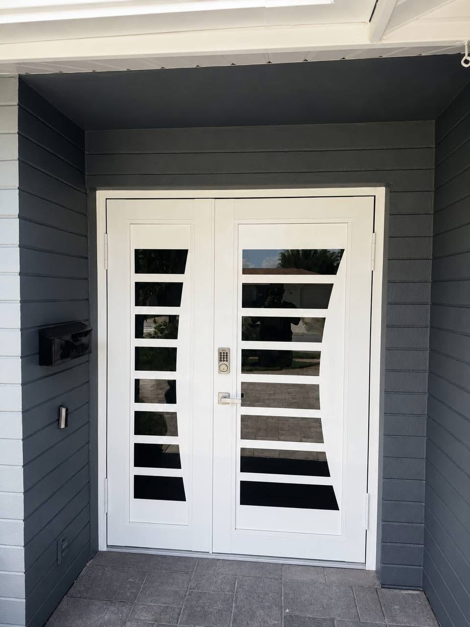 White entry door with oval glass and arched transom