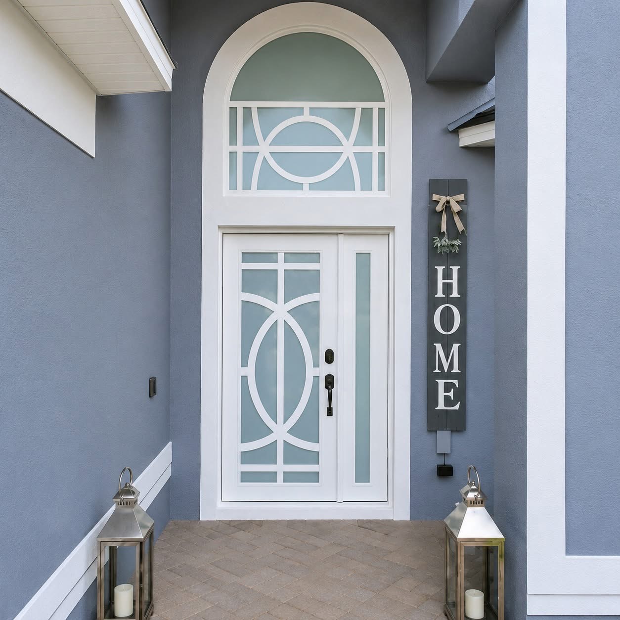 White impact entry door with circular geometric design and arched transom