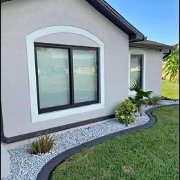 White-frame impact window with black trim on residential exterior